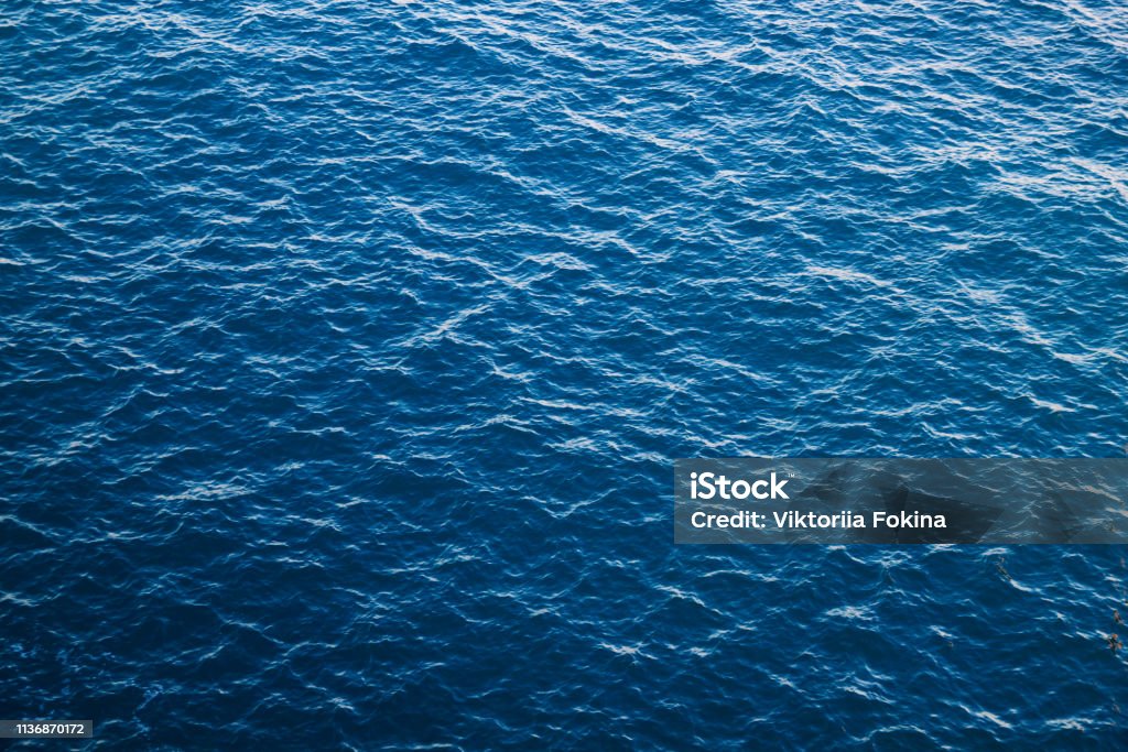 Blue sea water background, Atlantic Blue sea with ribbed textured waves, top view. Mediterranean Sea in Italy, copy space Sea Stock Photo