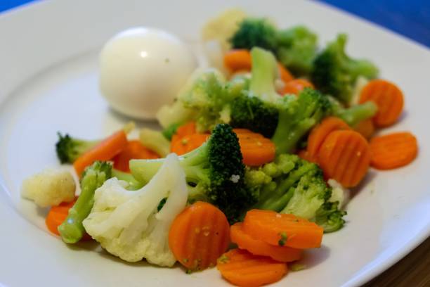 istock Cooked colorful vegetables with eggs on the plate. 1136870408