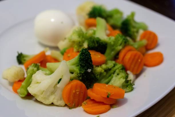 istock Cooked colorful vegetables with eggs on the plate. 1136870445