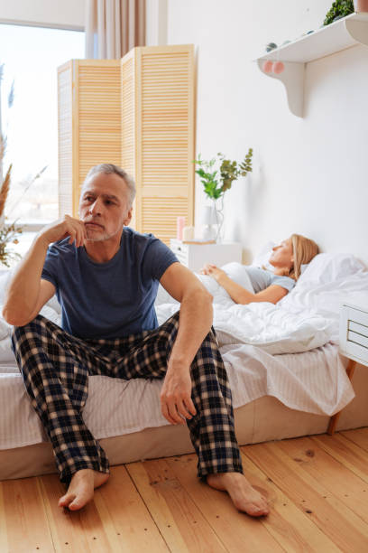 istock Businessman sitting on bed feeling overloaded with thoughts 1136871044