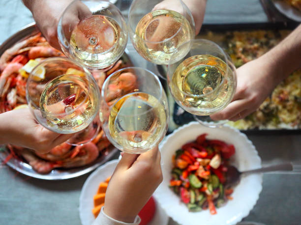 The top view on a table with food The top view on a table with food and toast with white wine. Gratin, salad and seafood on the table seafood gratin stock pictures, royalty-free photos & images