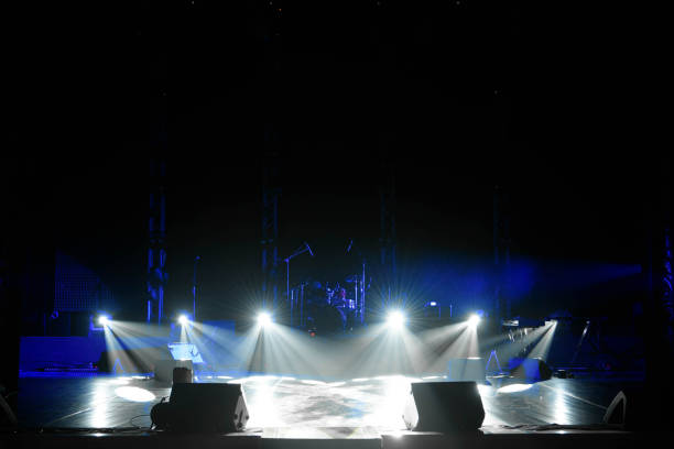 istock scene, stage light with colored spotlights and smoke 1136873833