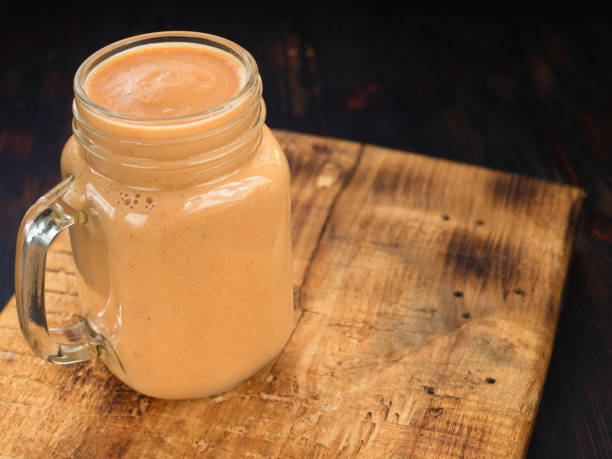 istock Pumpkin Smoothie. Healthy blended juice on rustic wooden table 1136874098