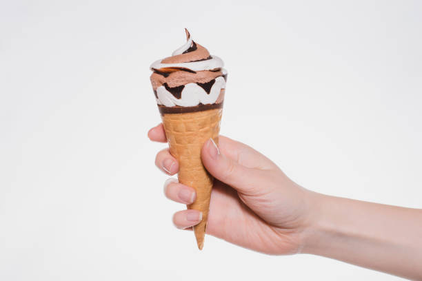 Photo of Close up photo of woman's hand holding showing presenting tasty yummy beautiful ice-cream with chocolate sauce isolated on white background cutout copy-space