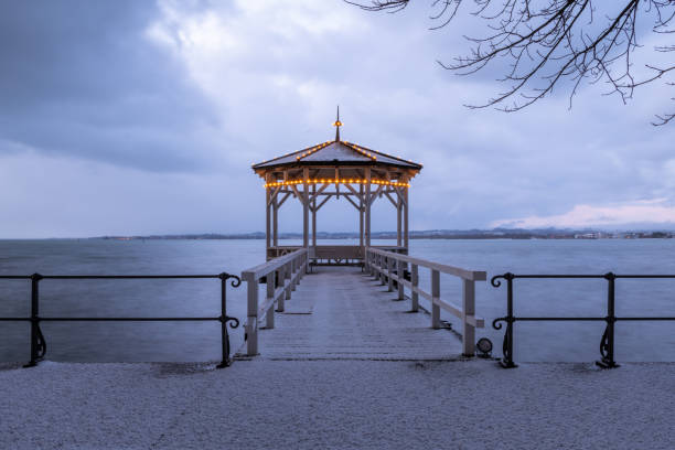 Fisherman's footbridge on lake Constance (Bodensee) in Bregenz Fisherman's footbridge on lake Constance (Bodensee) in Bregenz (Austria) on a stormy day in early spring, after snowfall bregenz stock pictures, royalty-free photos & images