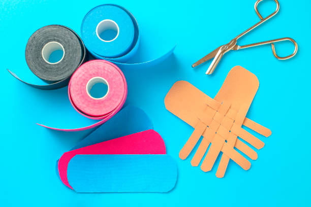 istock colored kinesiotapes with a pair of scissors 1136878800