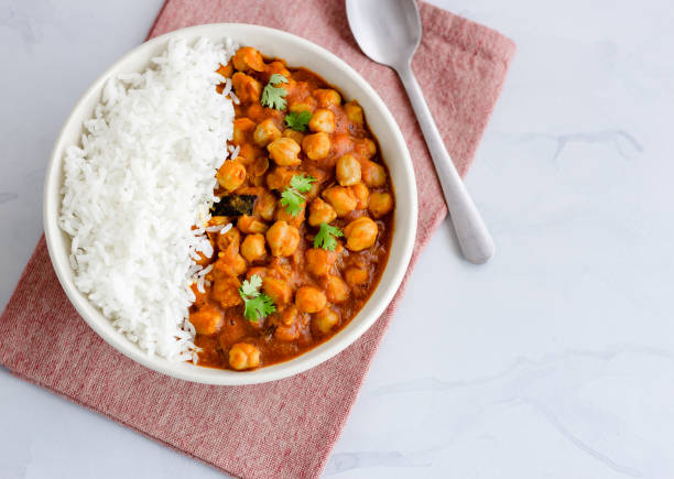 Vegan and Low Carb Chickpea Curry and Rice Vegan and Low Carb Chickpea Curry with Rice in a Bowl Directly Above Photo. Healthy Indian Chickpea Curry. chick pea photos stock pictures, royalty-free photos & images