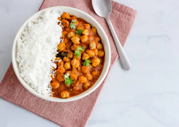 Vegan and Low Carb Chickpea Curry with Rice in a Bowl Directly Above Photo. Healthy Indian Chickpea Curry.