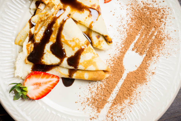 istock Russian thin pancakes (blini), with strawberry and chocolate sauce 1136881759