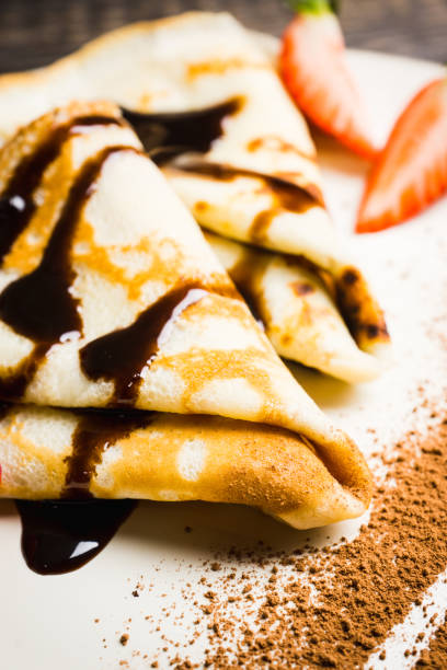 istock Russian thin pancakes (blini), with strawberry and chocolate sauce 1136881765