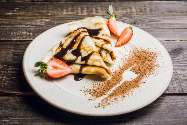 istock Russian thin pancakes (blini), with strawberry and chocolate sauce 1136881769