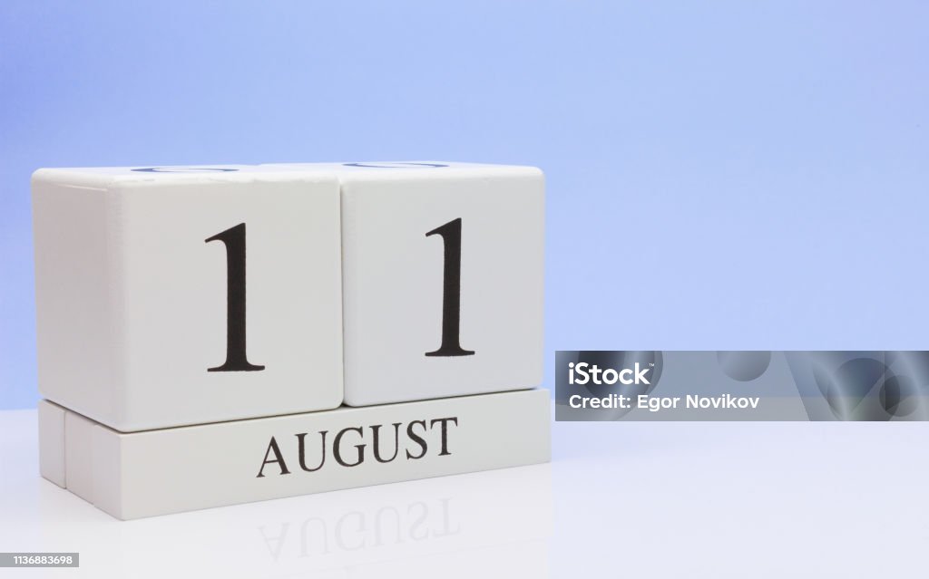 August 11st. Day 11 of month, daily calendar on white table with reflection, with light blue background. Summer time, empty space for text 2019 Stock Photo