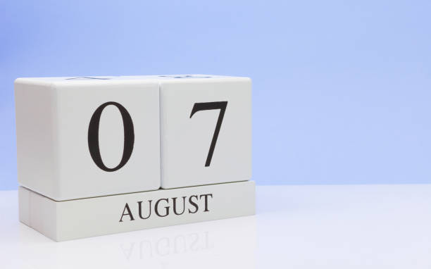 istock August 07st. Day 7 of month, daily calendar on white table with reflection, with light blue background. Summer time, empty space for text 1136883721
