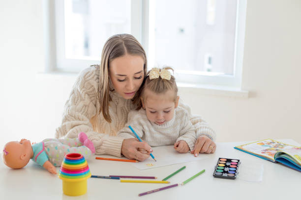 istock Mother and daughter painting together 1136885191