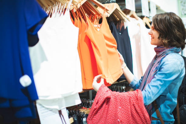 istock Woman in clothing store 1136885886