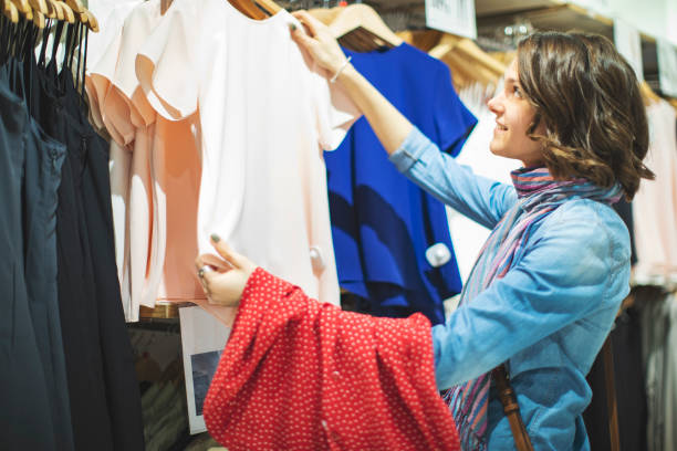 istock Woman in clothing store 1136885895