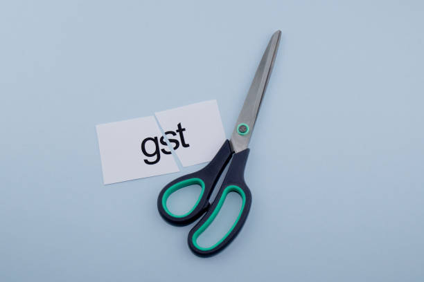 istock gst.Hand cutting paper with scissors 1136885908