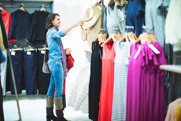 istock Woman in clothing store 1136885939