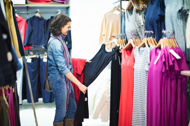 istock Woman in clothing store 1136885944