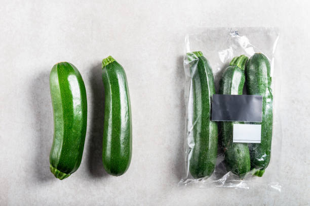 istock Courgettes in plastic bag VS paper bag. Choose less plastic concept 1136888592