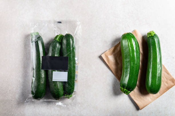 istock Courgettes in plastic bag VS paper bag. Choose less plastic concept 1136888600