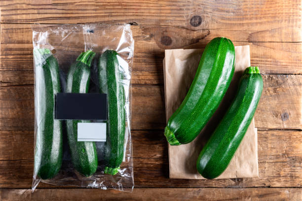 istock Courgettes in plastic bag VS paper bag. Choose less plastic concept 1136888602