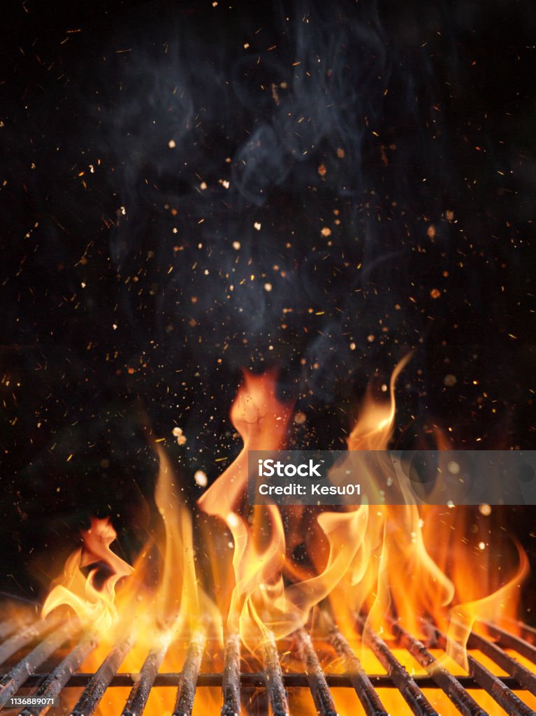 Empty flaming charcoal grill with open fire. Empty flaming charcoal grill with open fire, ready for product placement. Barbecue Grill Stock Photo