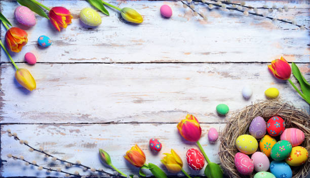 istock Easter Card - Painted Eggs And Tulips On Vintage Plank 1136889208