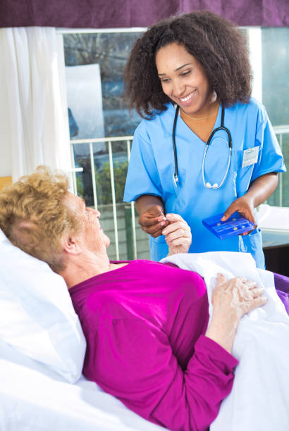 istock Friendly nurse giving pills to senior patient 1136890479