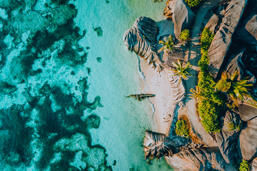 Aerial photo of famous paradise like tropical beach Anse Source D Argent at La Digue island, Seychelles. Summer vacation, travel and lifestyle concept.