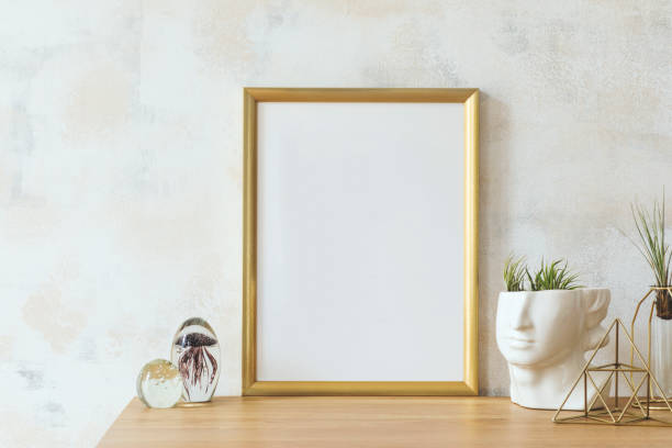 istock Modern and eclectic room interior with abstract wiped walls, gold mock up frame head sculpture, glassy balls and plants .Stylish space with design accessories. Eclectic home decor. Real photo. 1136895352
