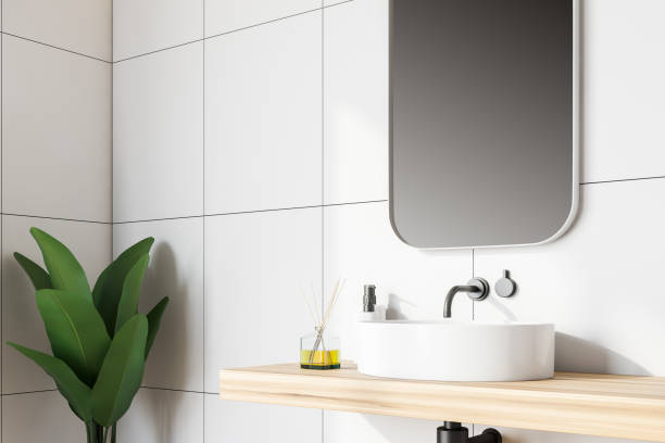 istock Side view of white tile bathroom with sink 1136896752