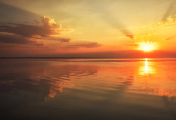 istock Dramatic sunset sky with clouds over lake. Composition of nature 1136898221