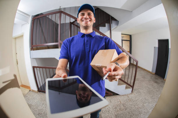 istock Postman at the door viewed through a spy hole 1136900914