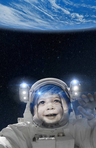 istock Child astronaut waving at Earth from space 1136901884
