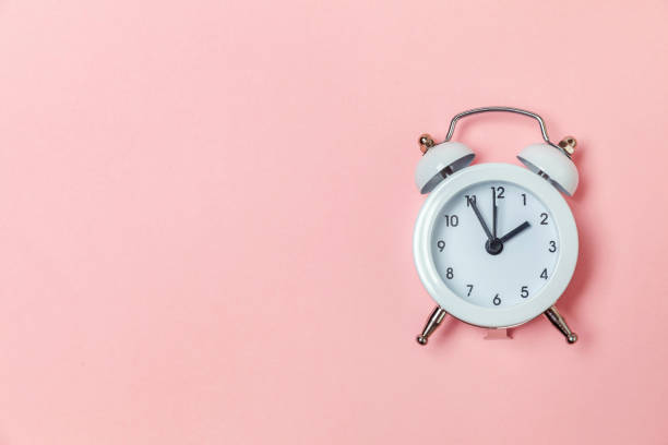 istock Vintage alarm clock Isolated on pink pastel background 1136901951