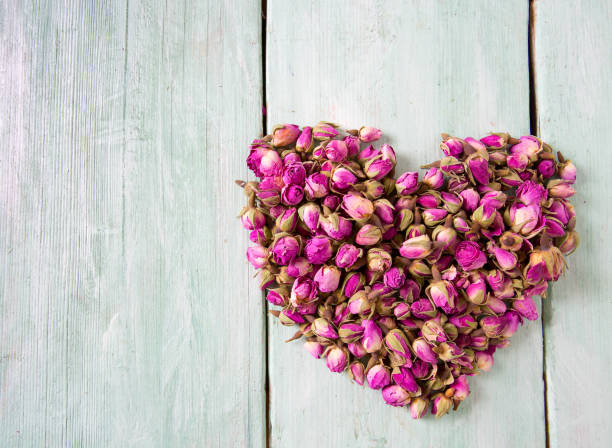 istock dried rose buds on turquoise wooden surface 1136901956