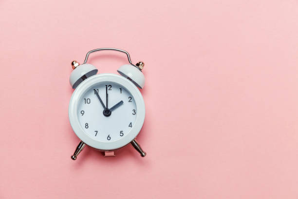 istock Vintage alarm clock Isolated on pink pastel background 1136901961