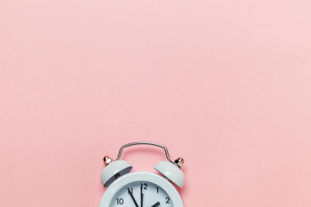 istock Vintage alarm clock Isolated on pink pastel background 1136901980