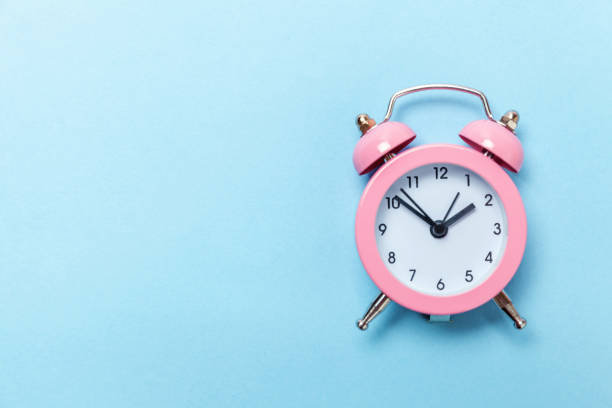 istock Vintage alarm clock Isolated on blue pastel background 1136902110