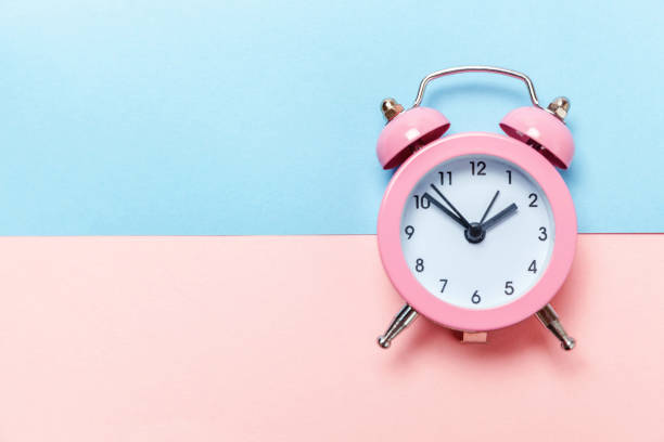 istock Vintage alarm clock Isolated on blue and pink pastel background 1136902116