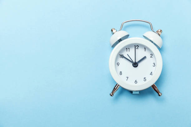 istock Vintage alarm clock Isolated on blue pastel background 1136902121