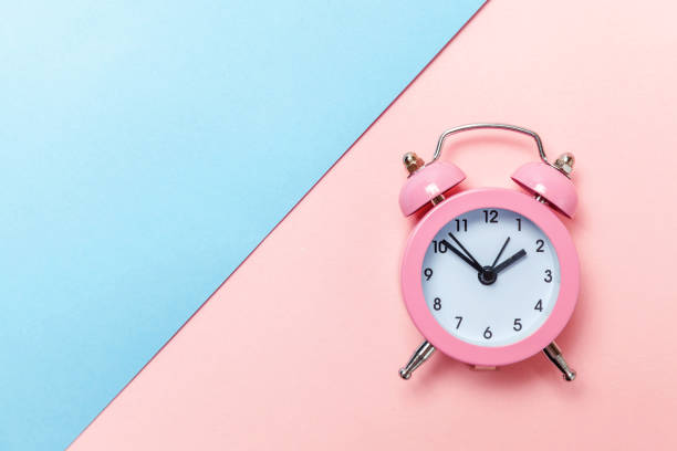 istock Vintage alarm clock Isolated on blue and pink pastel background 1136902149