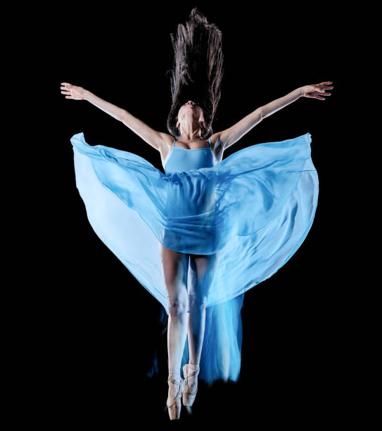 istock young woman ballet dancer dancing isolated black background light painting 1136903784