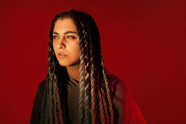 istock Attractive girl with dreadlocks. Red background. 1136904461