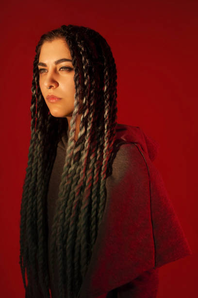 istock Attractive girl with dreadlocks. Red background. 1136905051