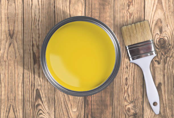istock Open paint jar and brush on wooden background, top view 1136906714