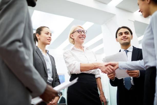istock Female Boss Greeting Partner 1136909077