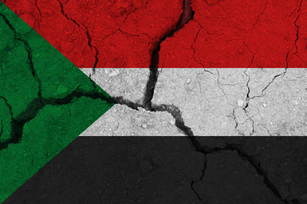 istock sudan flag on the cracked earth 1136916430