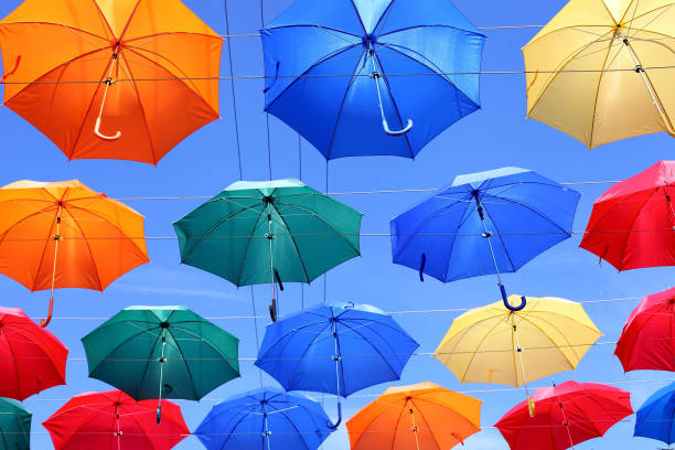 istock colorful umbrellas on blue sky background 1136917242